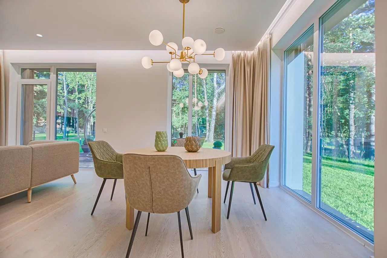 Bright, tidy dining room with large windows onto the garden