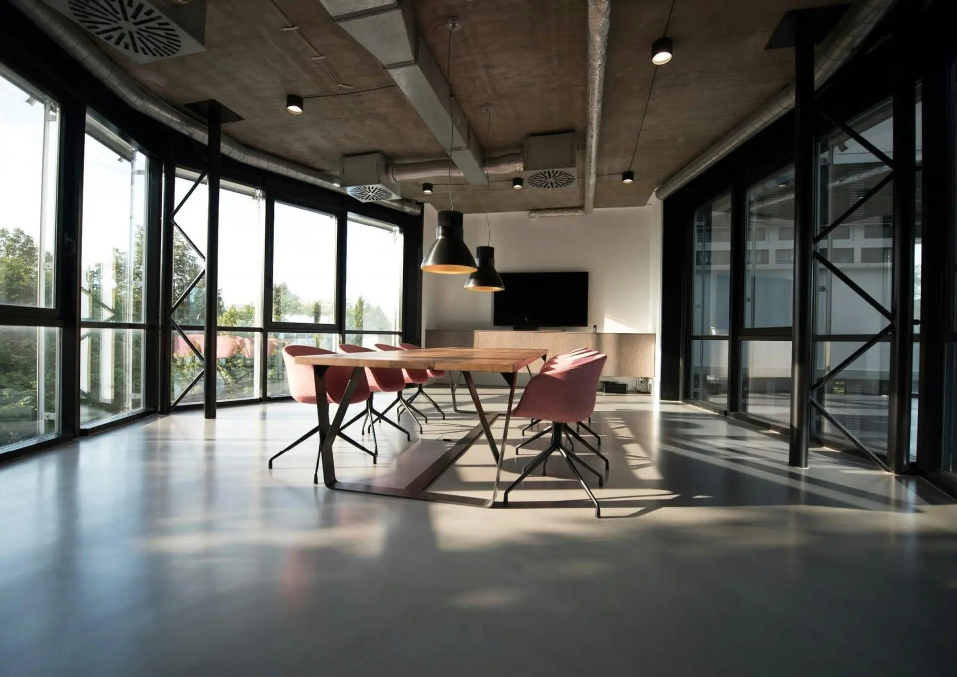 Bright open-plan office with a meeting table and large windows