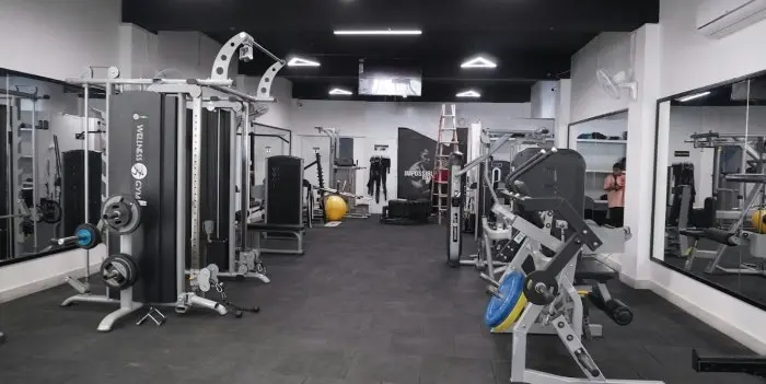 Gym floor with weight machines and mirrors