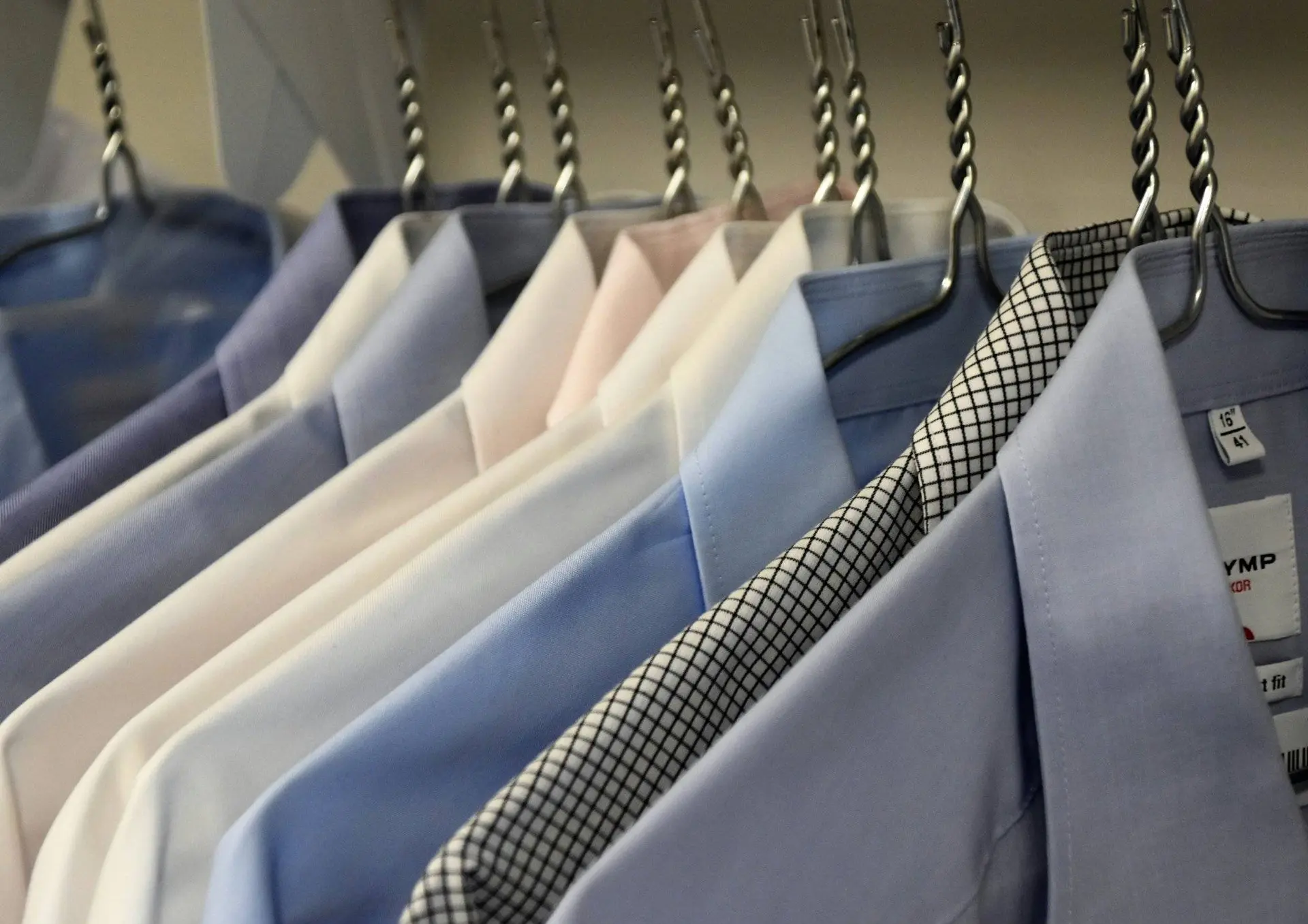 Ironed shirts hanging on hangers
