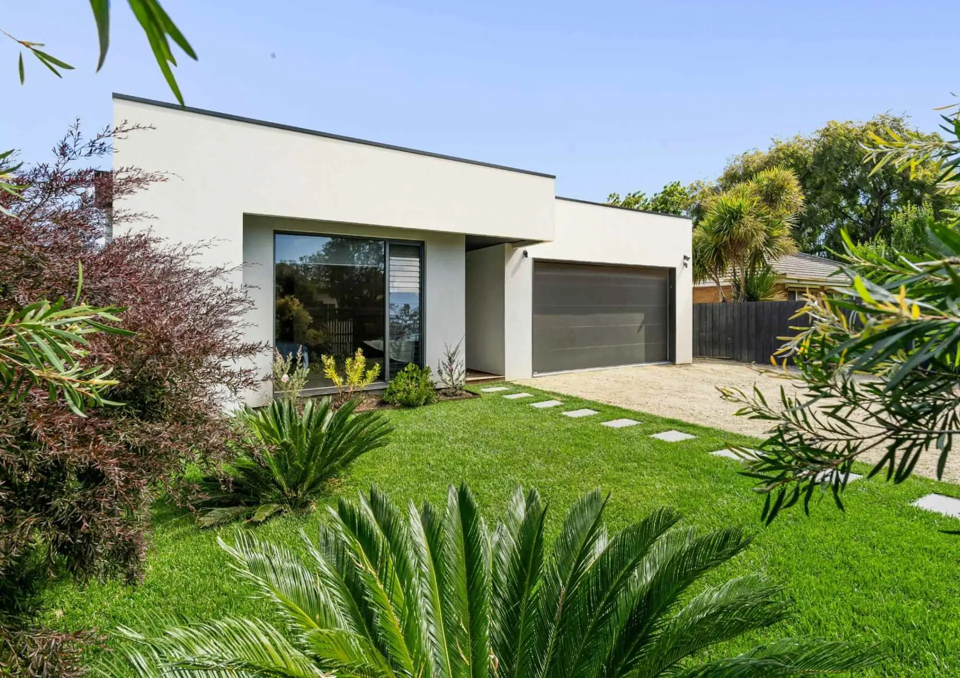 Modern house with a well-kept lawn and plants