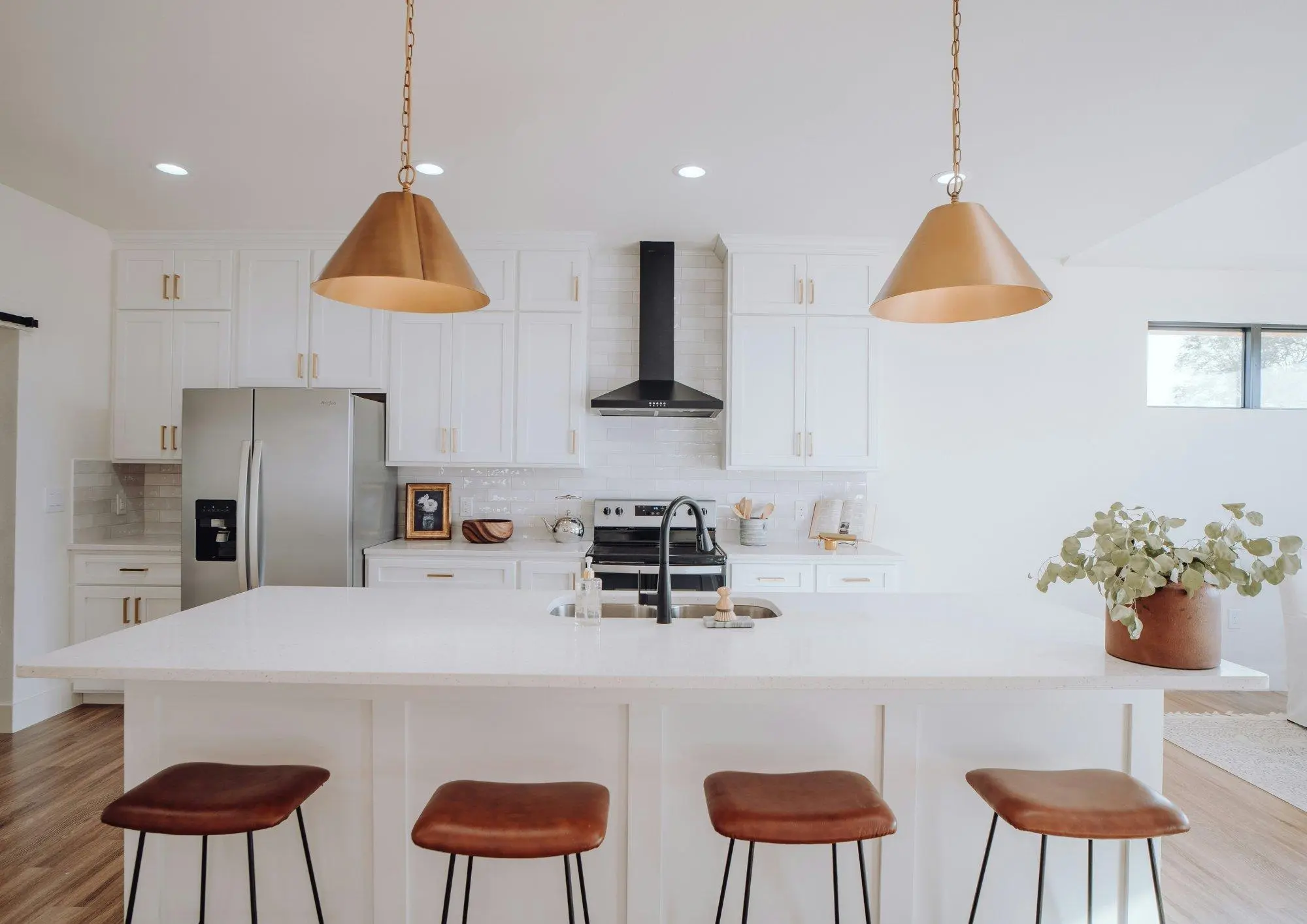 Bright white kitchen with an island and stools